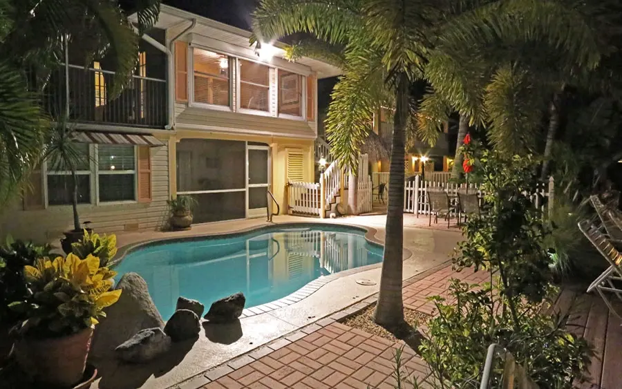 Pool at Manatee Bay Inn lit up at dusk